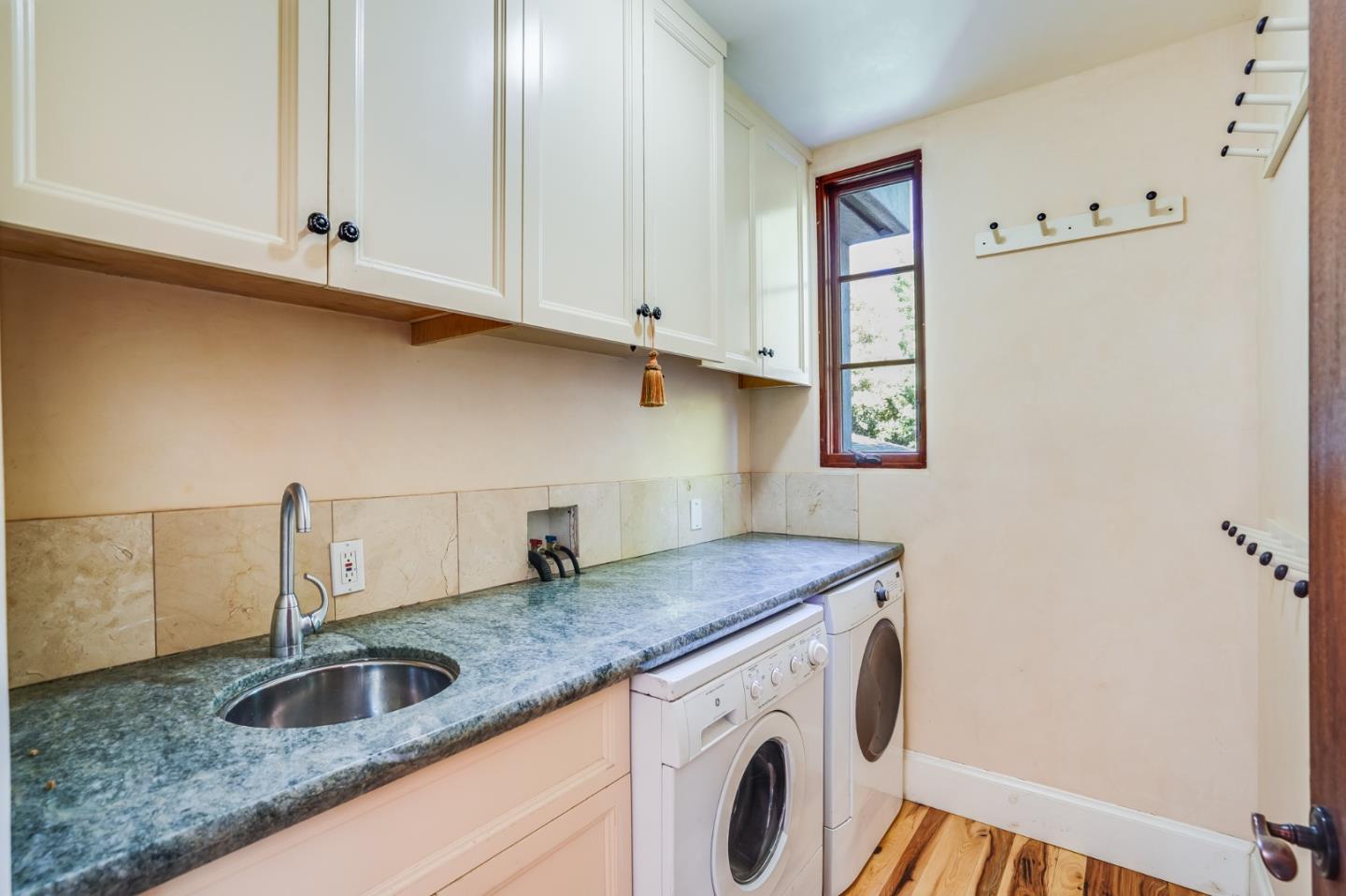 720 Edgewood Road San Mateo, CA 94402 - Photo 39 of 56 a kitchen with granite countertop white cabinets and a sink