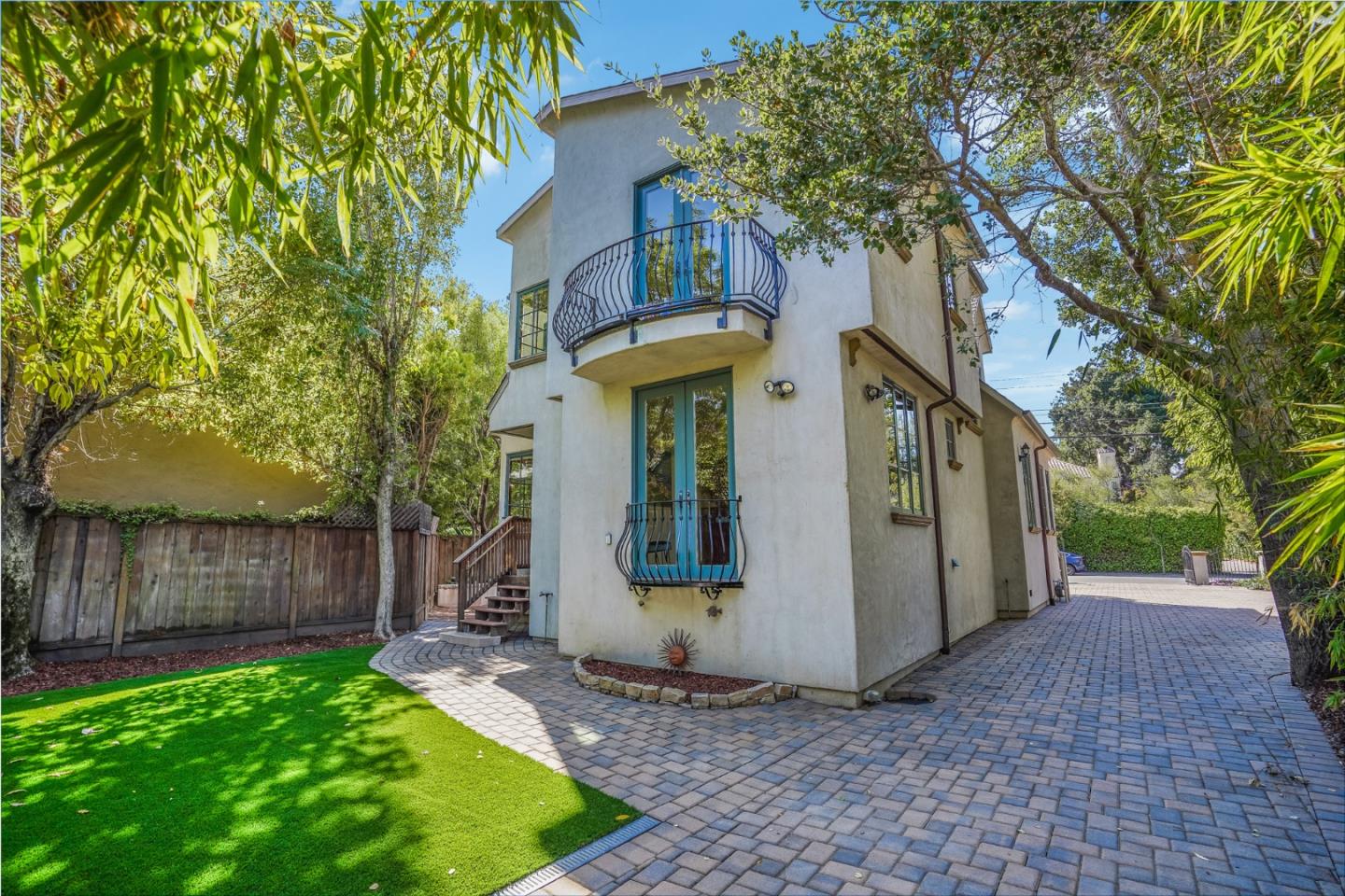 720 Edgewood Road San Mateo, CA 94402 - Photo 41 of 56 a view of a white house with a large tree and wooden fence