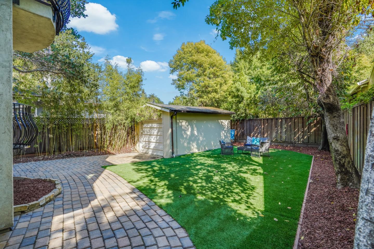 720 Edgewood Road San Mateo, CA 94402 - Photo 42 of 56 a view of backyard with a table and chairs and potted plants
