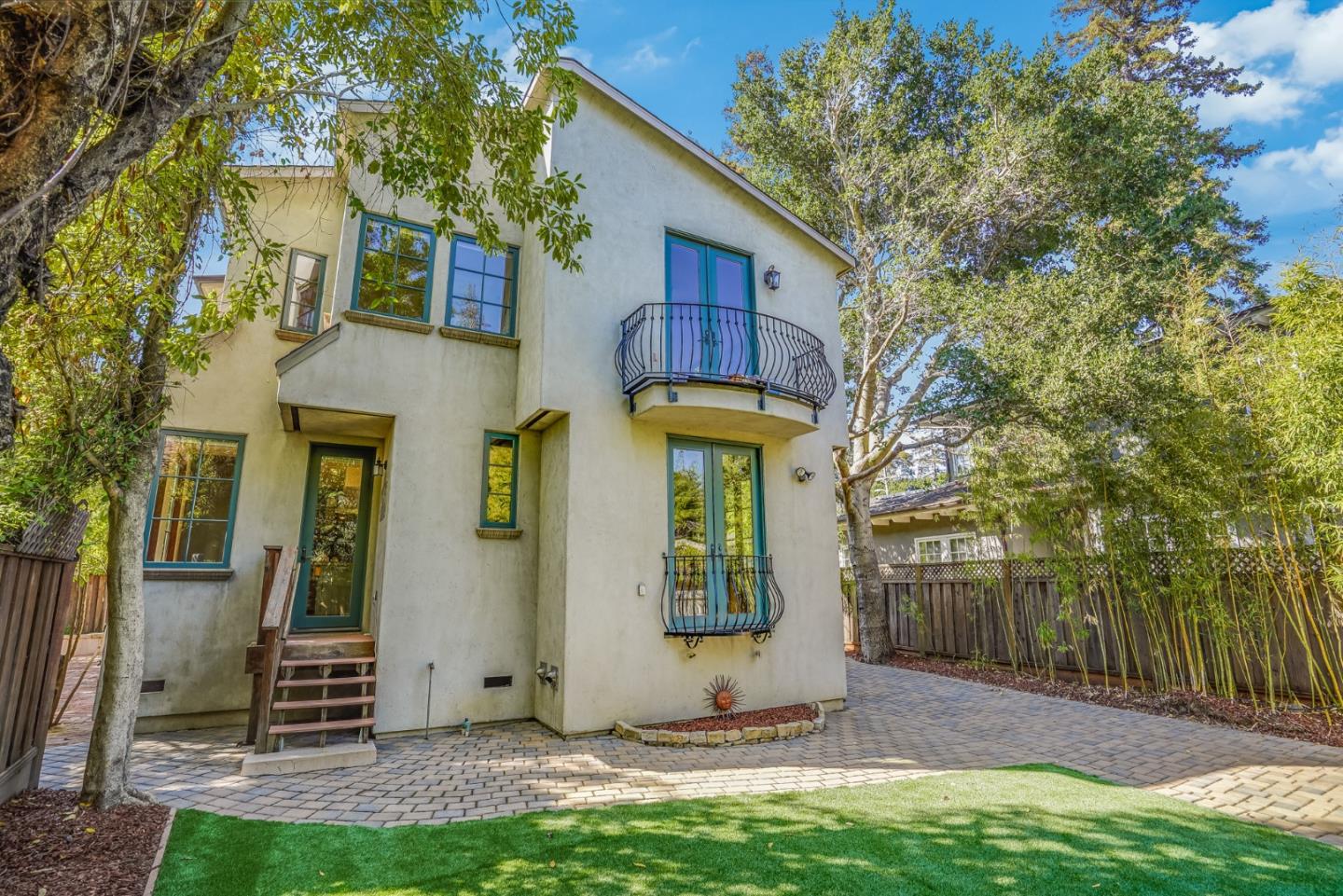 720 Edgewood Road San Mateo, CA 94402 - Photo 47 of 56 a view of a brick house with many windows and a big yard