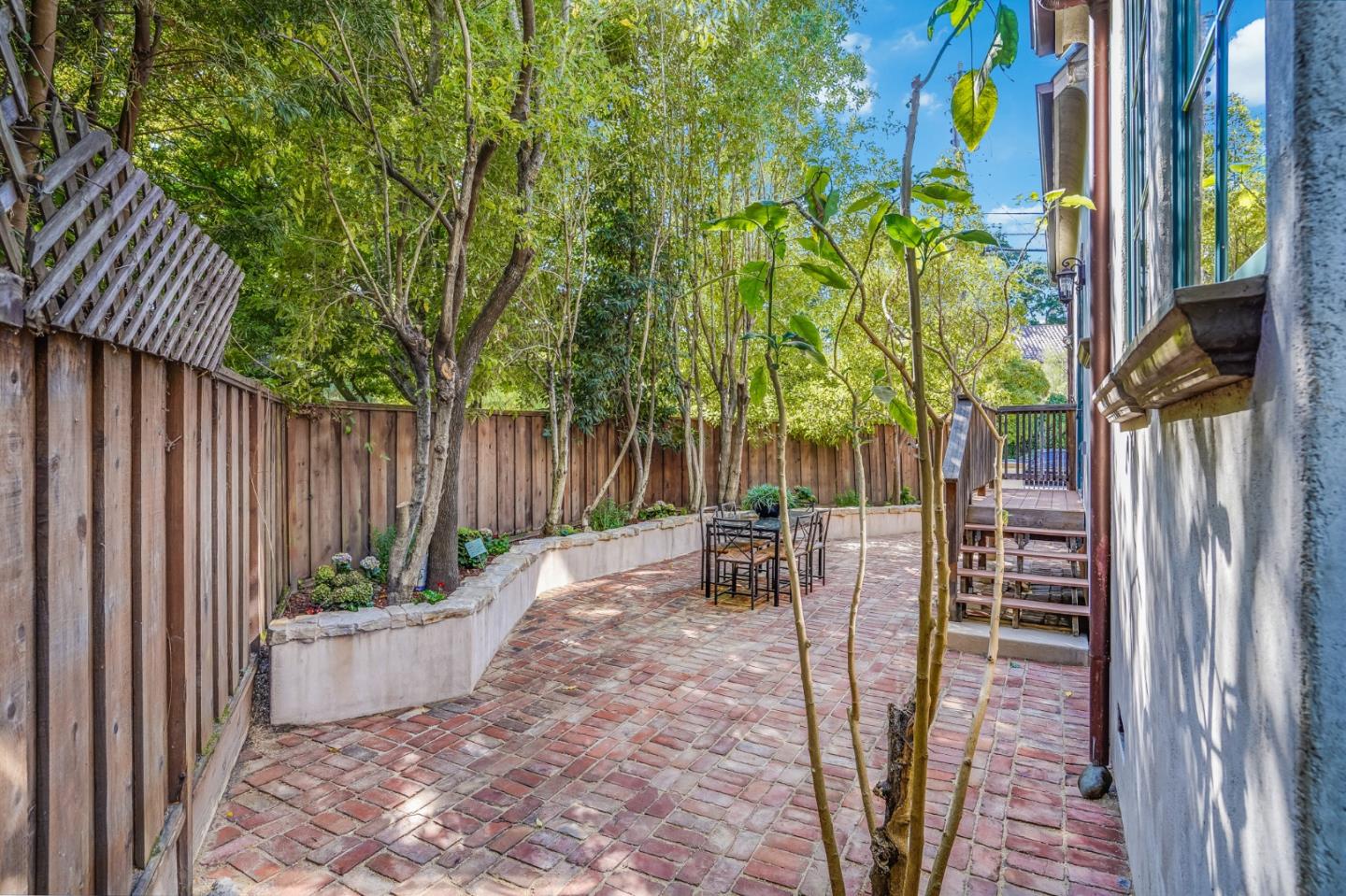 720 Edgewood Road San Mateo, CA 94402 - Photo 48 of 56 a view of a patio with table and chairs and potted plants