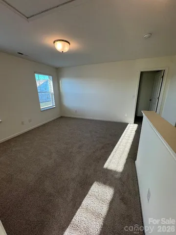 a view of a livingroom with an empty space and a window
