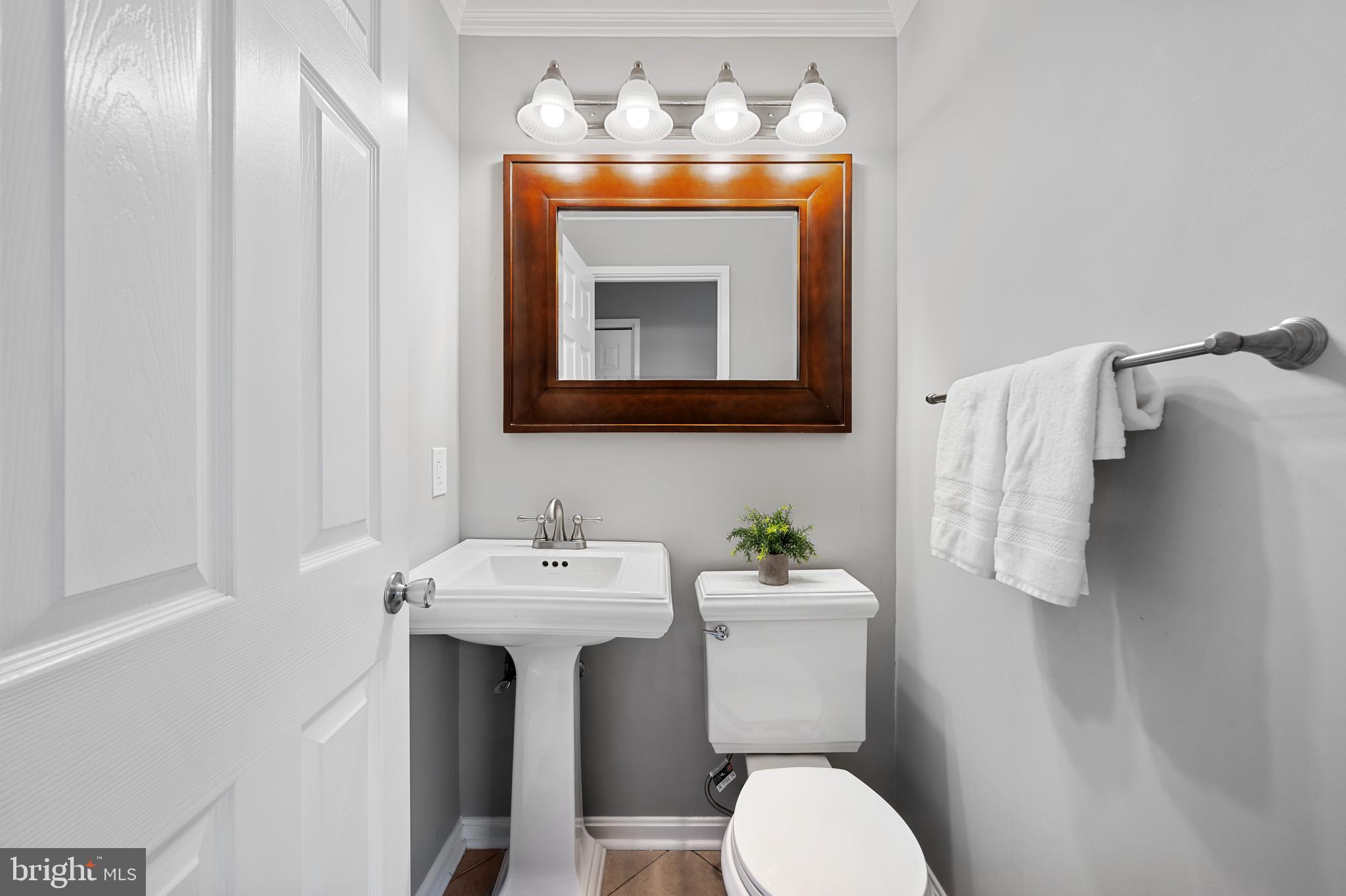 1403 Corey Lane Annapolis, MD 21401 - Photo 12 of 40 a bathroom with a sink mirror and toilet