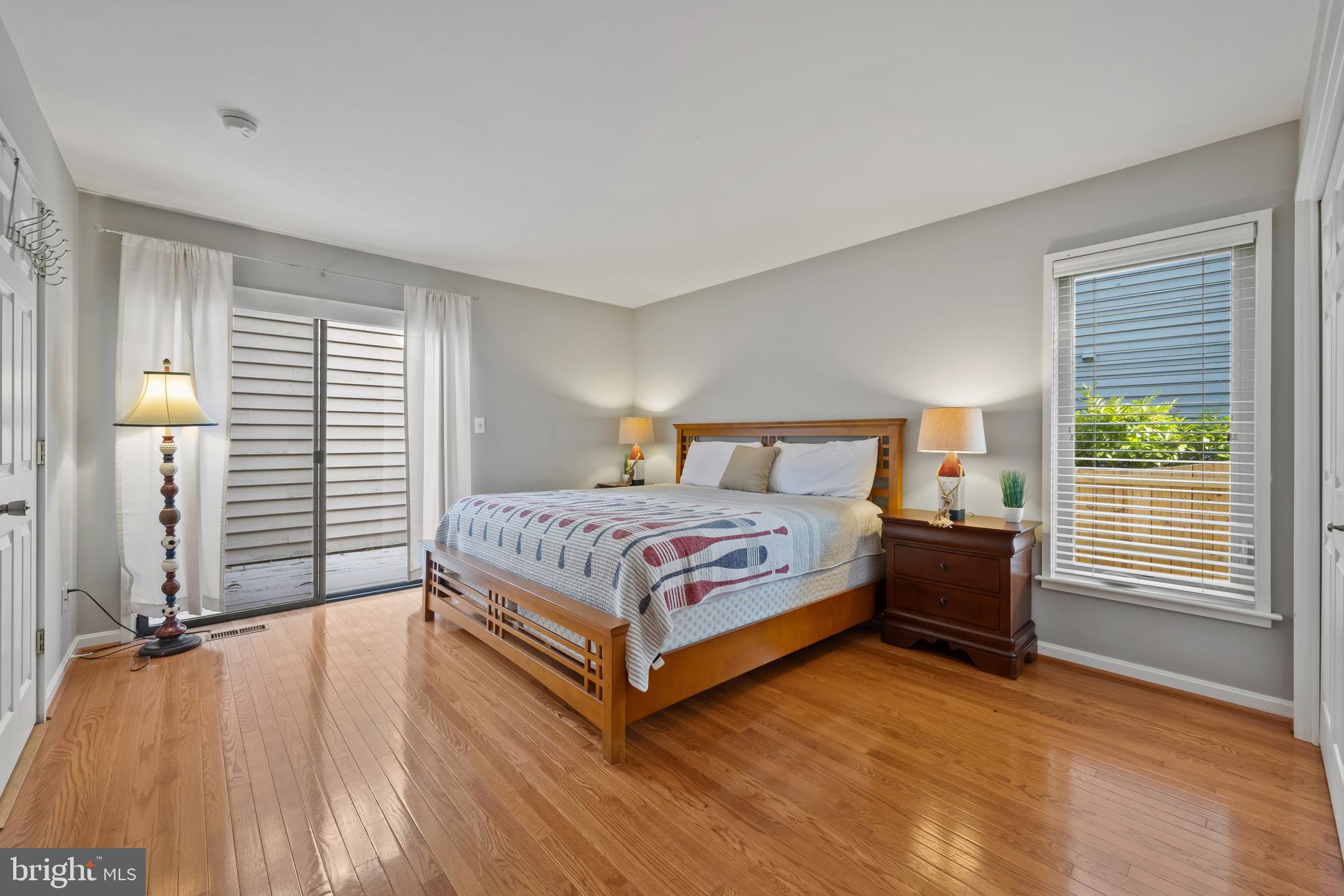 1403 Corey Lane Annapolis, MD 21401 - Photo 18 of 40 a bedroom with a bed and a flat tv screen on a dresser