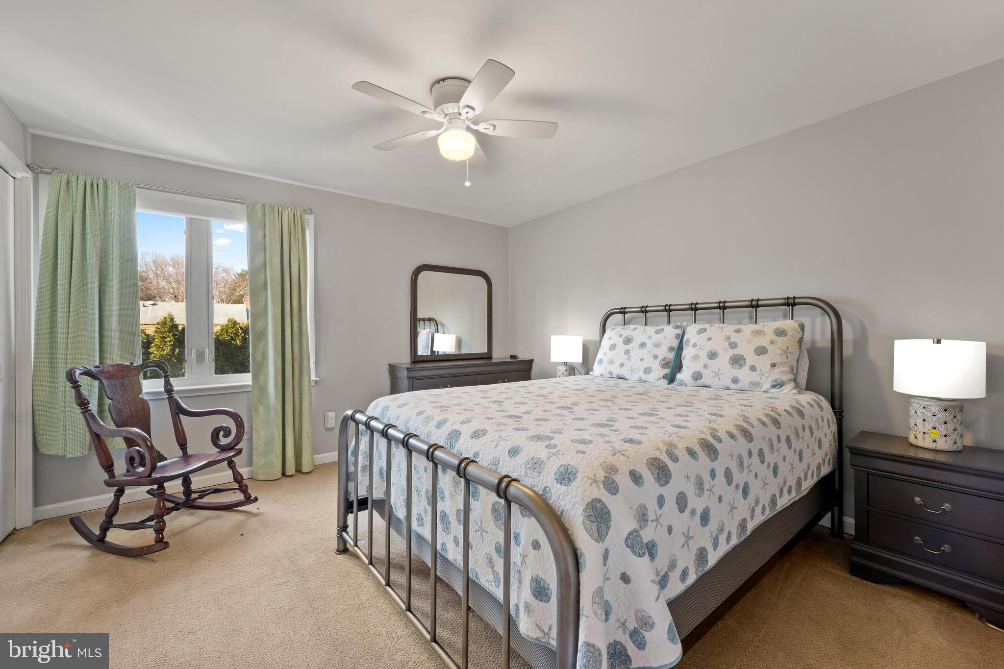 1403 Corey Lane Annapolis, MD 21401 - Photo 24 of 40 a bedroom with a bed a lamp and a chandelier