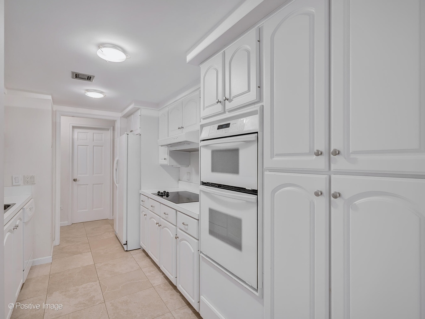 1401 Burr Oak Road, Unit 202B Hinsdale, IL 60521 - Photo 18 of 40 a kitchen with white cabinets and white appliances
