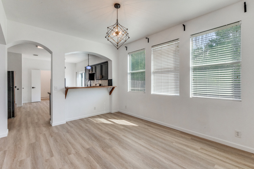 9204 Magna Carta Loop Austin, TX 78754 - Photo 8 of 27 a view of a kitchen with wooden floor and windows