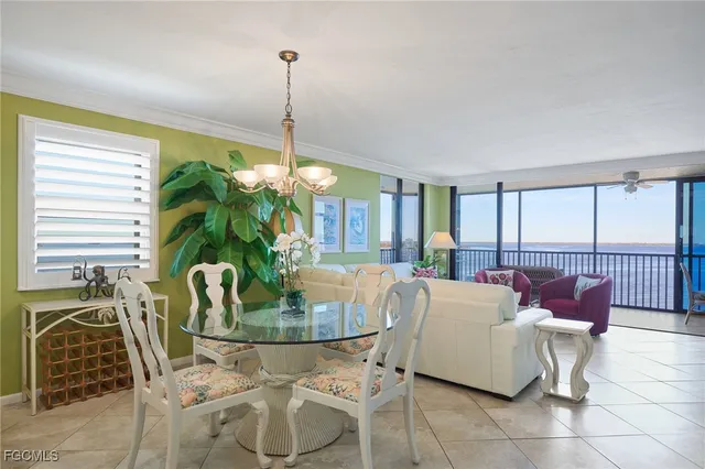 a view of a dining room with furniture and a chandelier