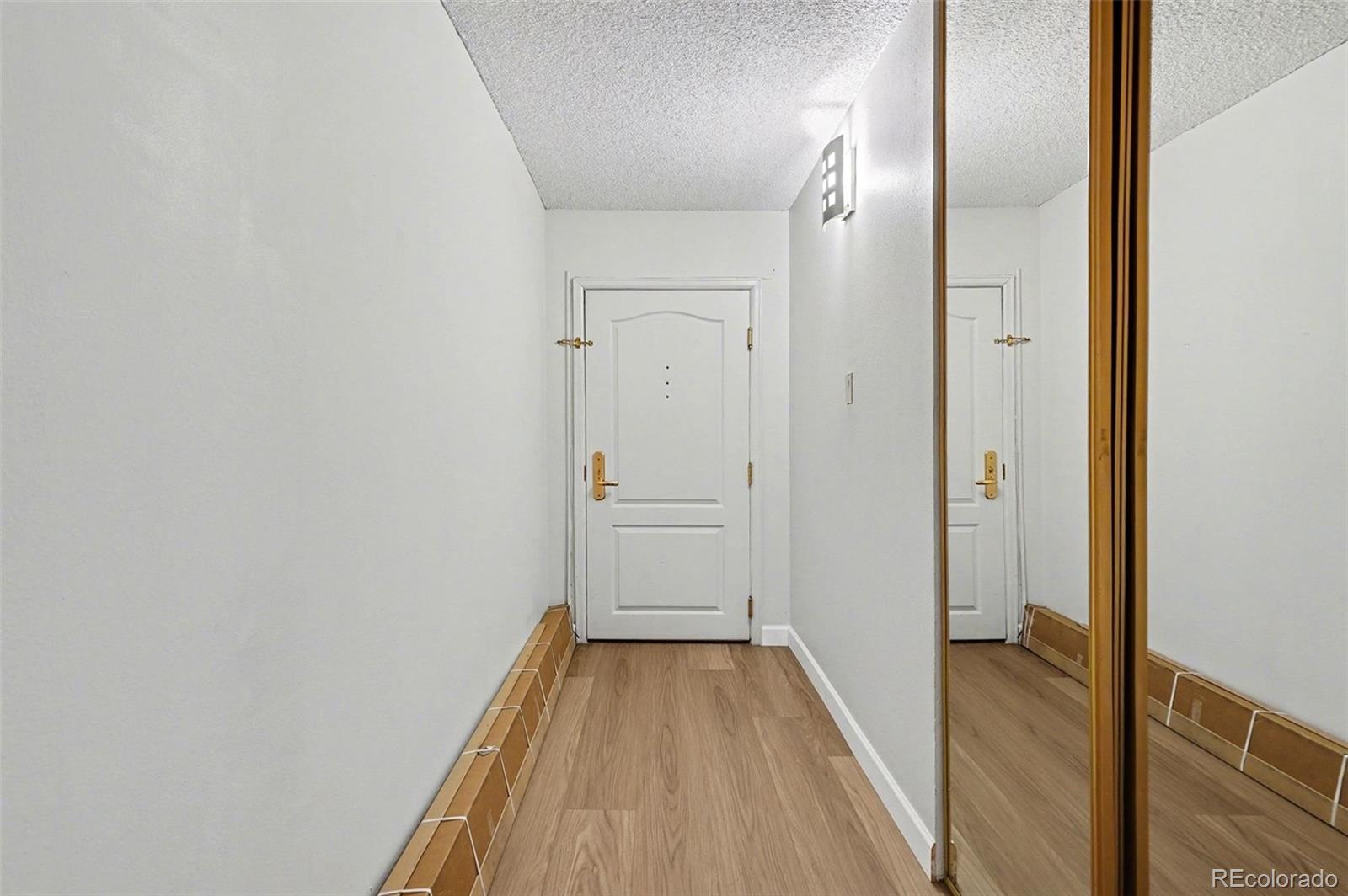 1020 15th Street, Unit 13N Denver, CO 80202 - Photo 12 of 12 a view of a hallway with wooden floor