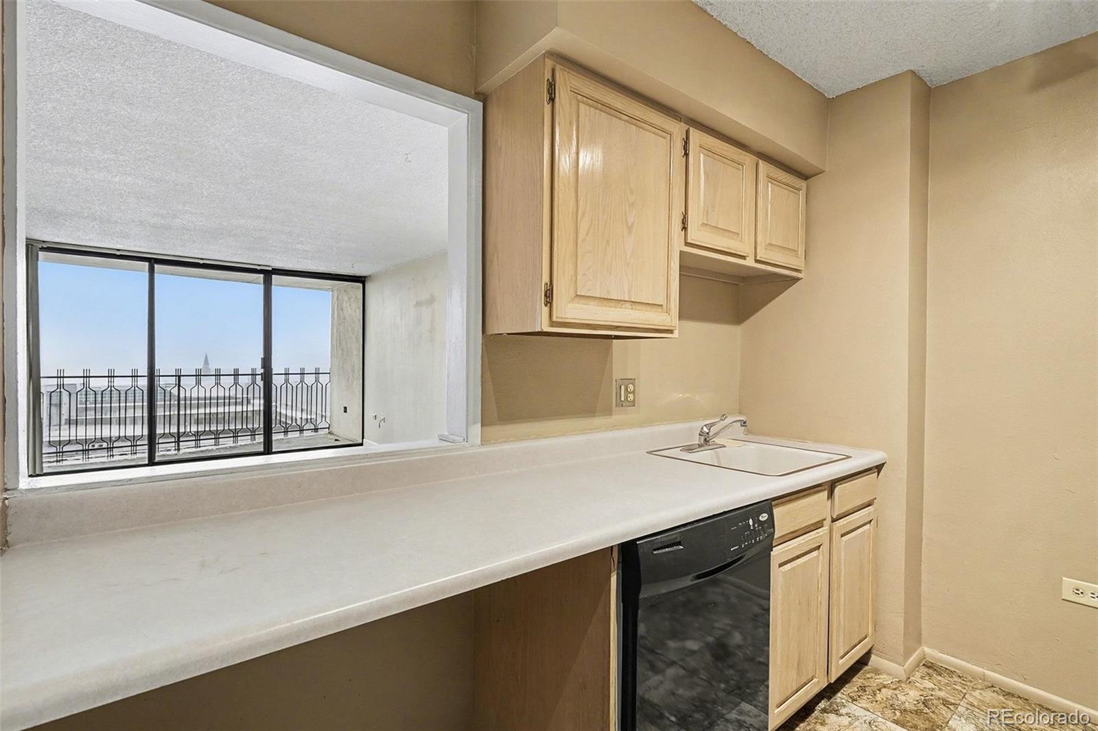 1020 15th Street, Unit 13N Denver, CO 80202 - Photo 3 of 12 a kitchen with a sink and a window