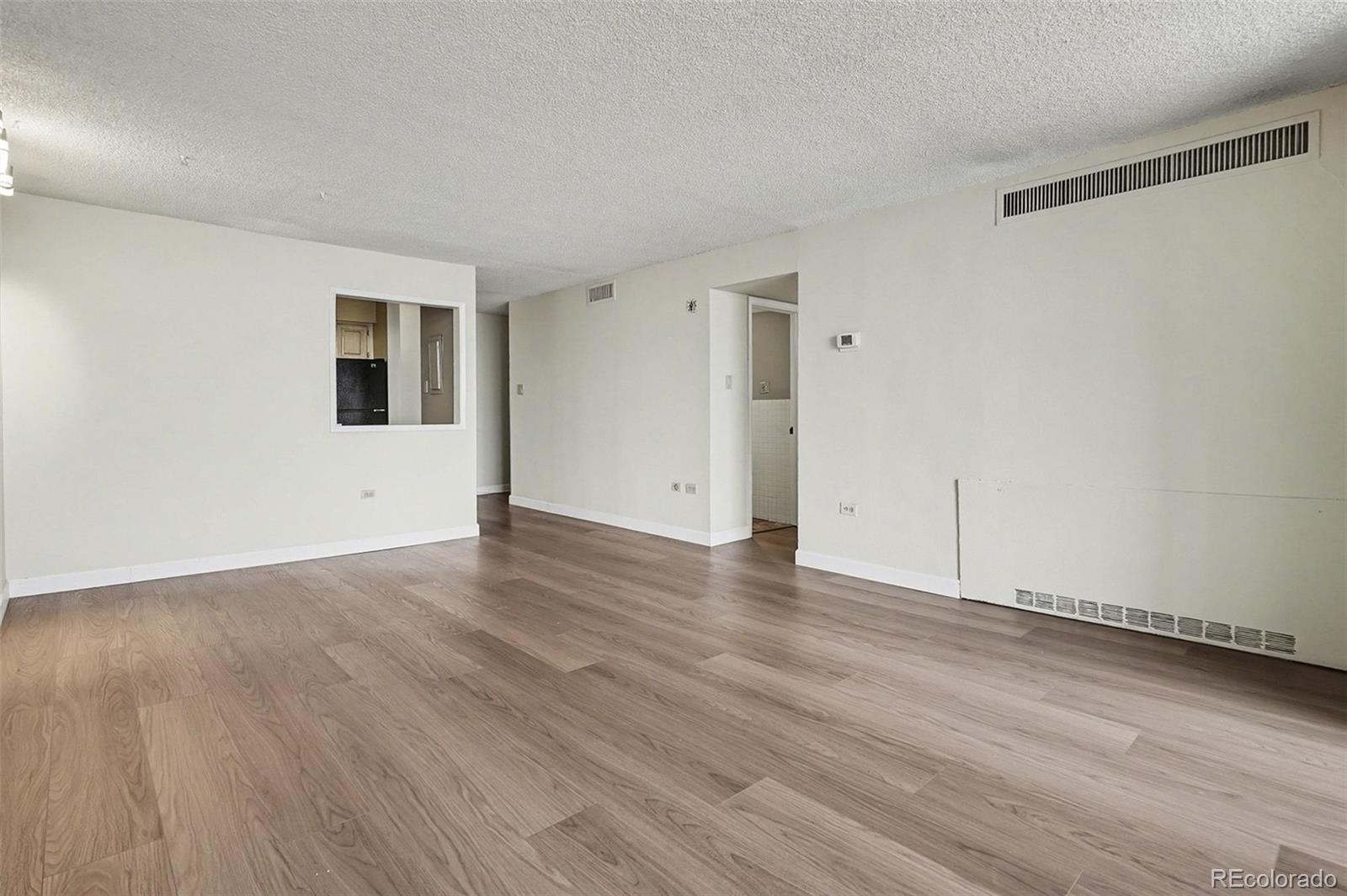 1020 15th Street, Unit 13N Denver, CO 80202 - Photo 5 of 12 a view of an empty room with wooden floor