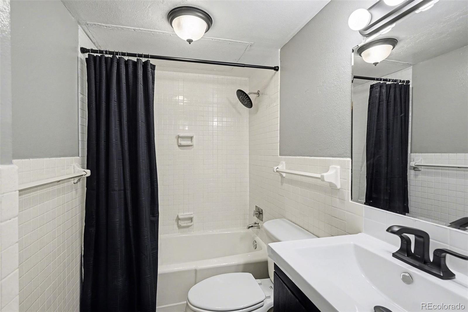 1020 15th Street, Unit 13N Denver, CO 80202 - Photo 6 of 12 a bathroom with a sink toilet and shower