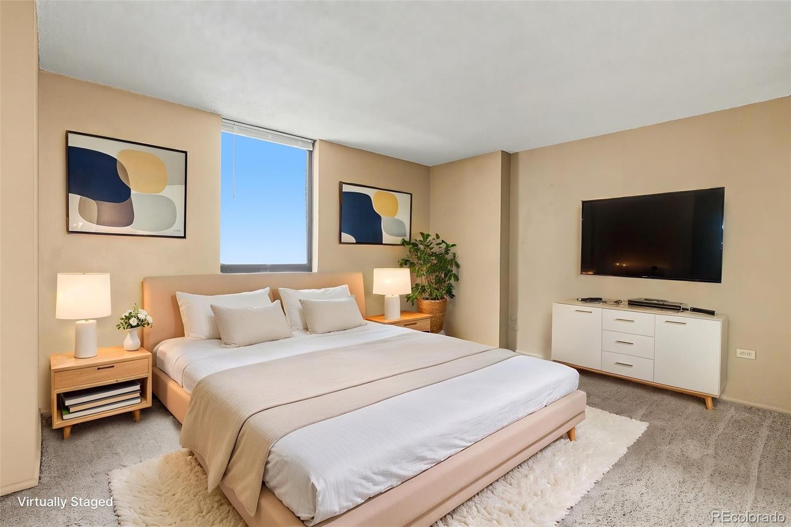 1020 15th Street, Unit 13N Denver, CO 80202 - Photo 8 of 12 a bedroom with a bed and a flat screen tv