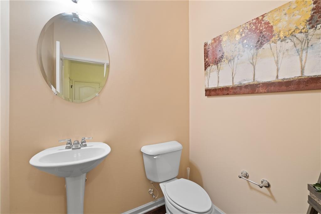 5715 Radford Loop Fairburn, GA 30213 - Photo 12 of 26 a bathroom with a toilet a sink and mirror
