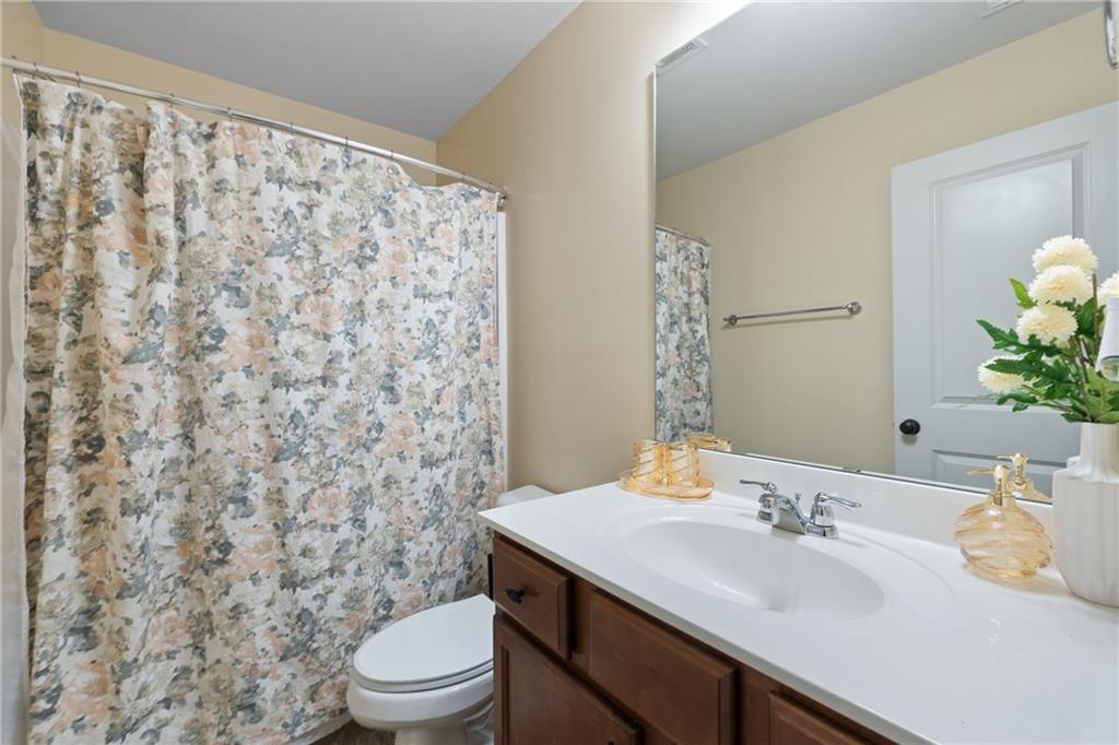 5715 Radford Loop Fairburn, GA 30213 - Photo 15 of 26 a bathroom with a sink toilet and shower