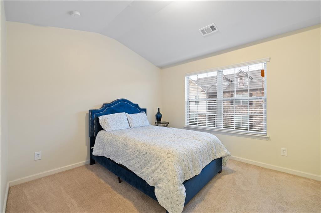 5715 Radford Loop Fairburn, GA 30213 - Photo 16 of 26 a bedroom with a bed and a window