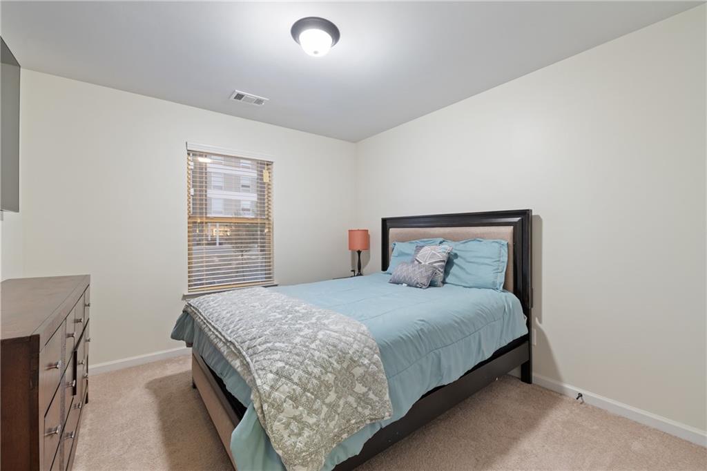 5715 Radford Loop Fairburn, GA 30213 - Photo 17 of 26 a bedroom with a bed and a window