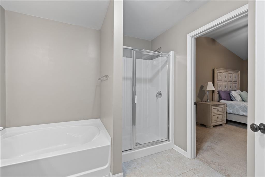 5715 Radford Loop Fairburn, GA 30213 - Photo 20 of 26 a bathroom with a bathtub and a shower