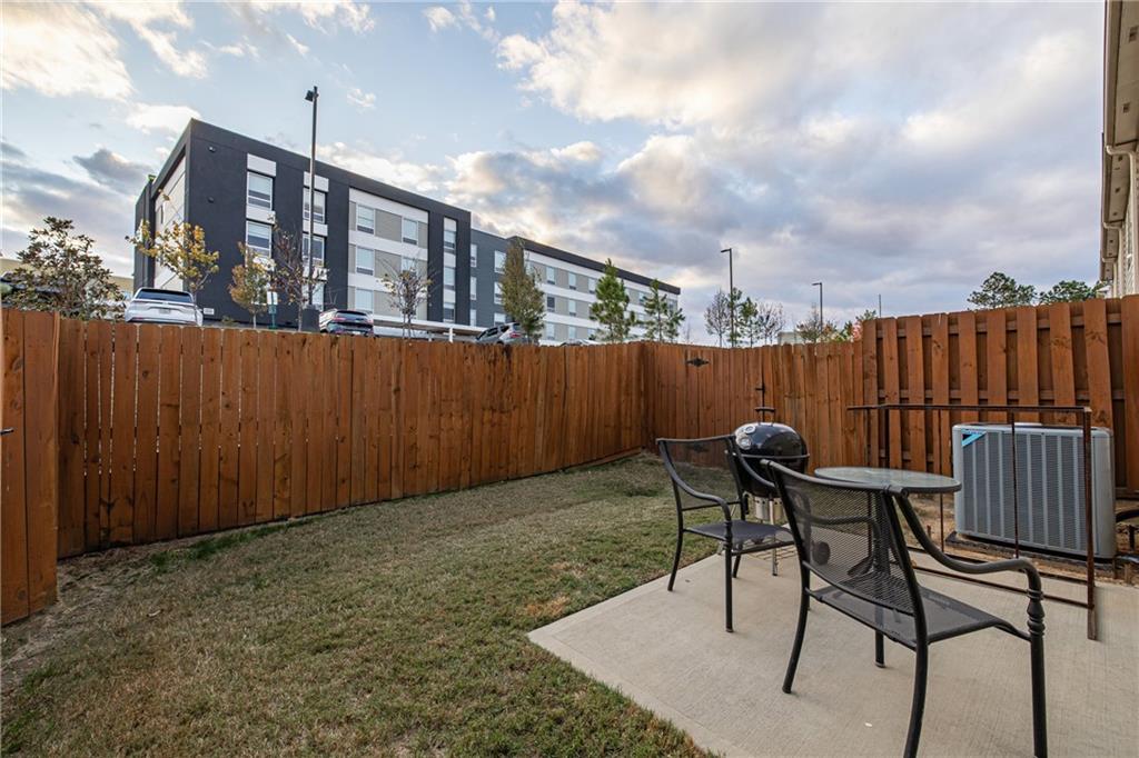5715 Radford Loop Fairburn, GA 30213 - Photo 22 of 26 a view of a chairs and table in the backyard