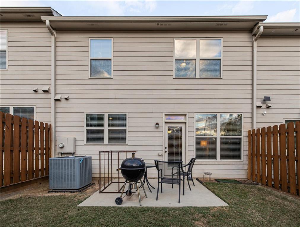 5715 Radford Loop Fairburn, GA 30213 - Photo 23 of 26 a view of backyard with two chairs and a large window