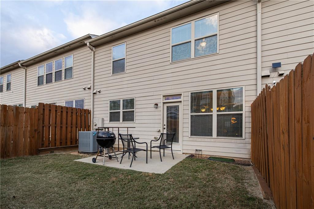 5715 Radford Loop Fairburn, GA 30213 - Photo 24 of 26 a view of a house with patio and wooden fence