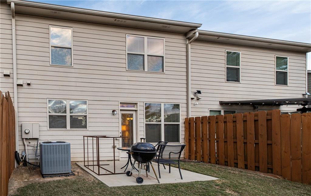 5715 Radford Loop Fairburn, GA 30213 - Photo 25 of 26 a balcony with table and chairs and wooden fence