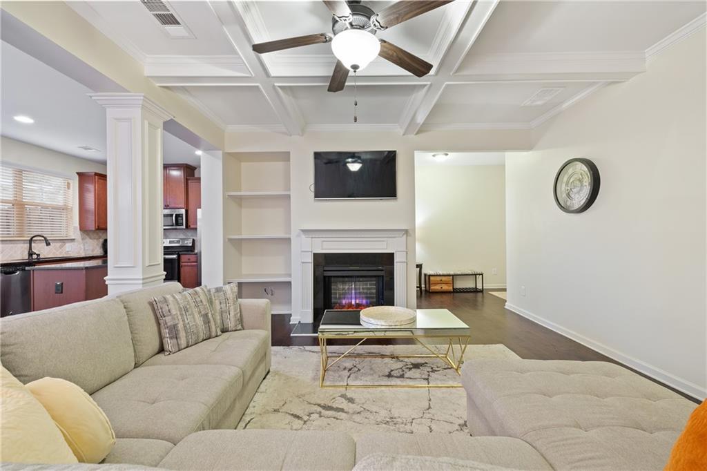 5715 Radford Loop Fairburn, GA 30213 - Photo 6 of 26 a living room with furniture a flat screen tv and a fireplace