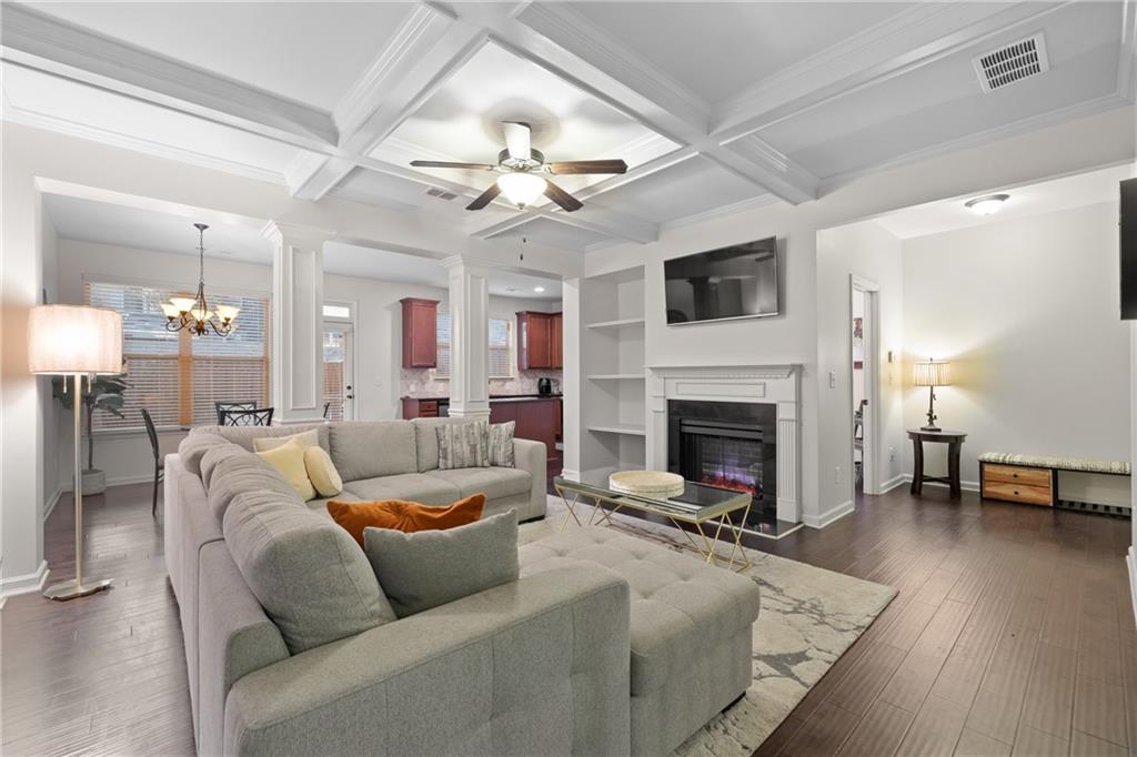 5715 Radford Loop Fairburn, GA 30213 - Photo 7 of 26 a living room with furniture a fireplace and a flat screen tv