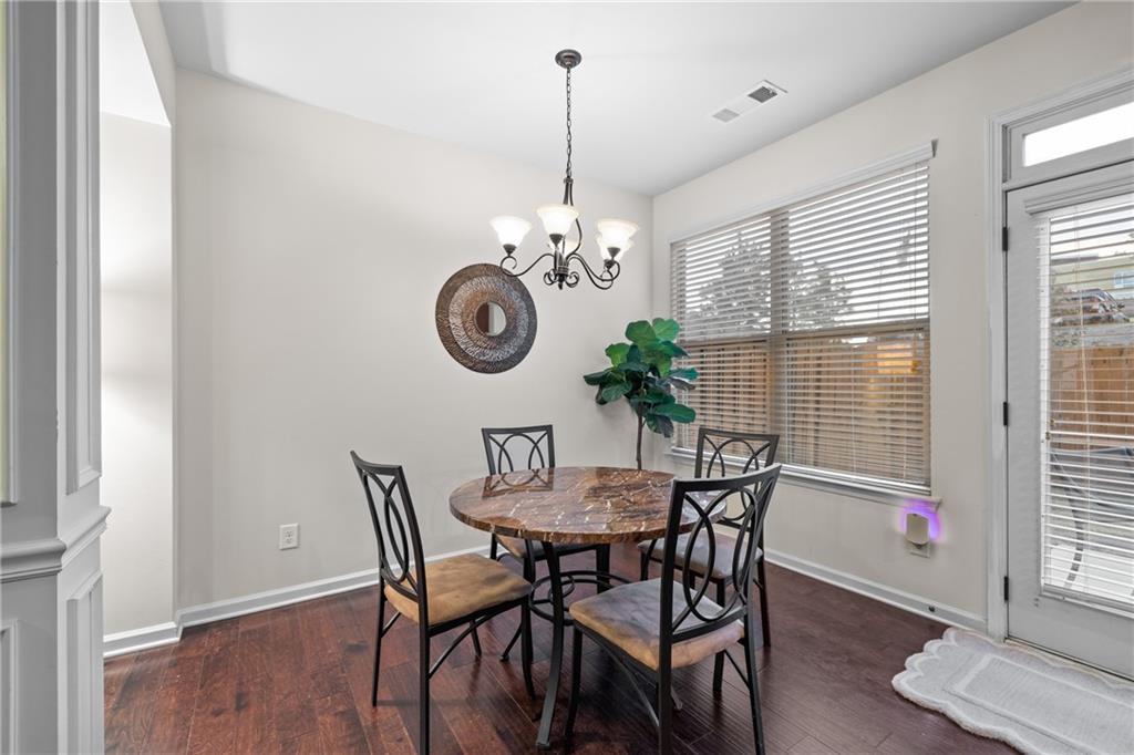 5715 Radford Loop Fairburn, GA 30213 - Photo 8 of 26 a view of a dining room with furniture window and wooden floor