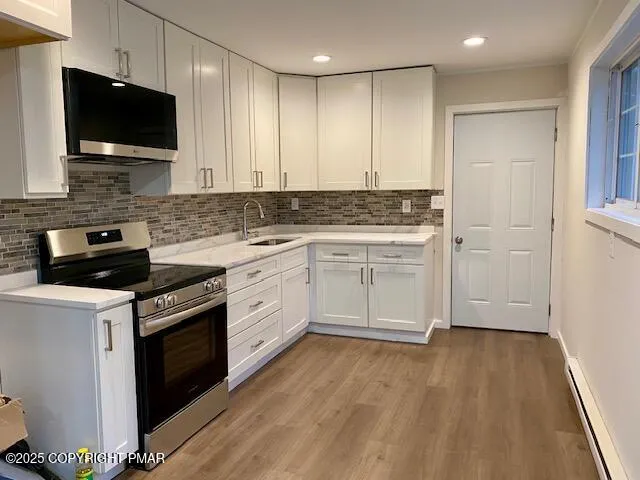 a kitchen with a sink stove and microwave