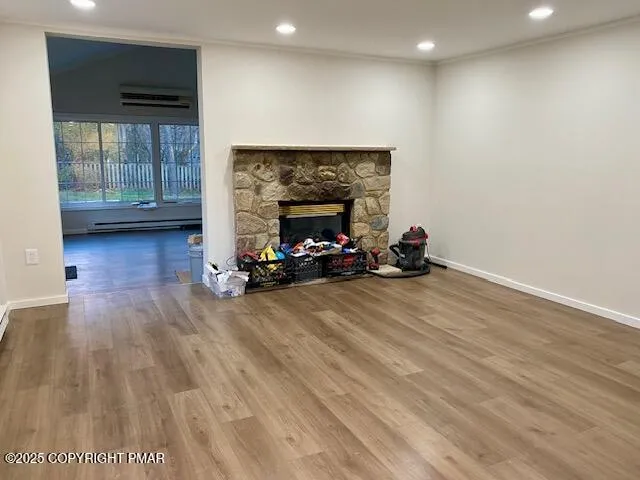 a living room with hard wood floors and a fireplace