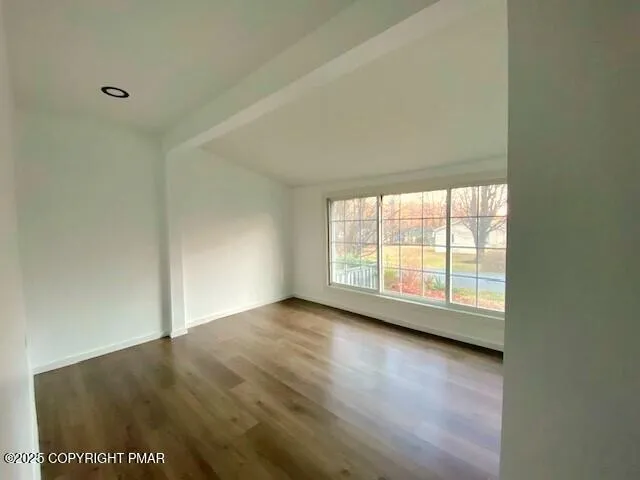 a view of an empty room with glass door