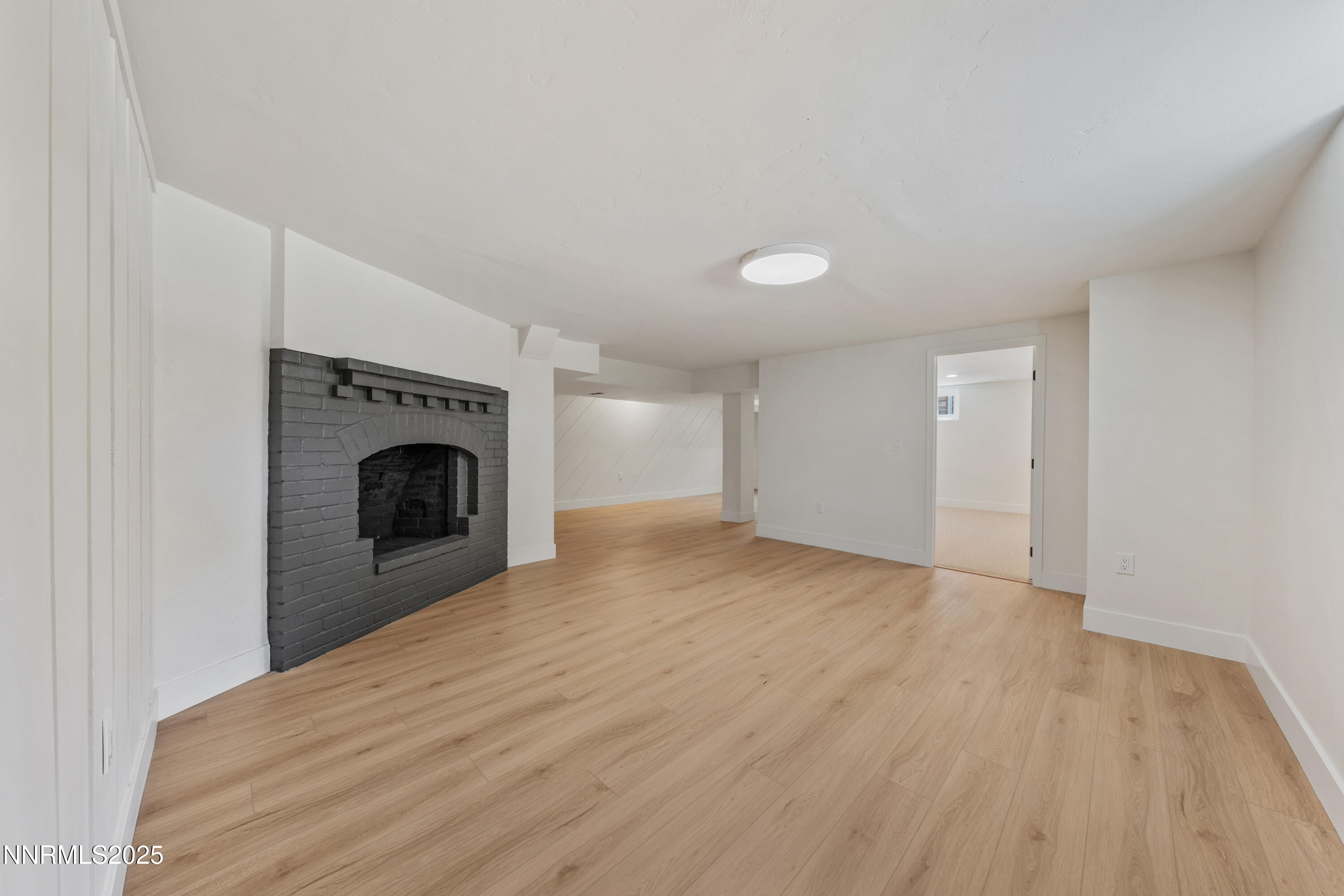 2303 Homestead Place Reno, NV 89509 - Photo 42 of 54 a view of empty room with wooden floor and a fireplace