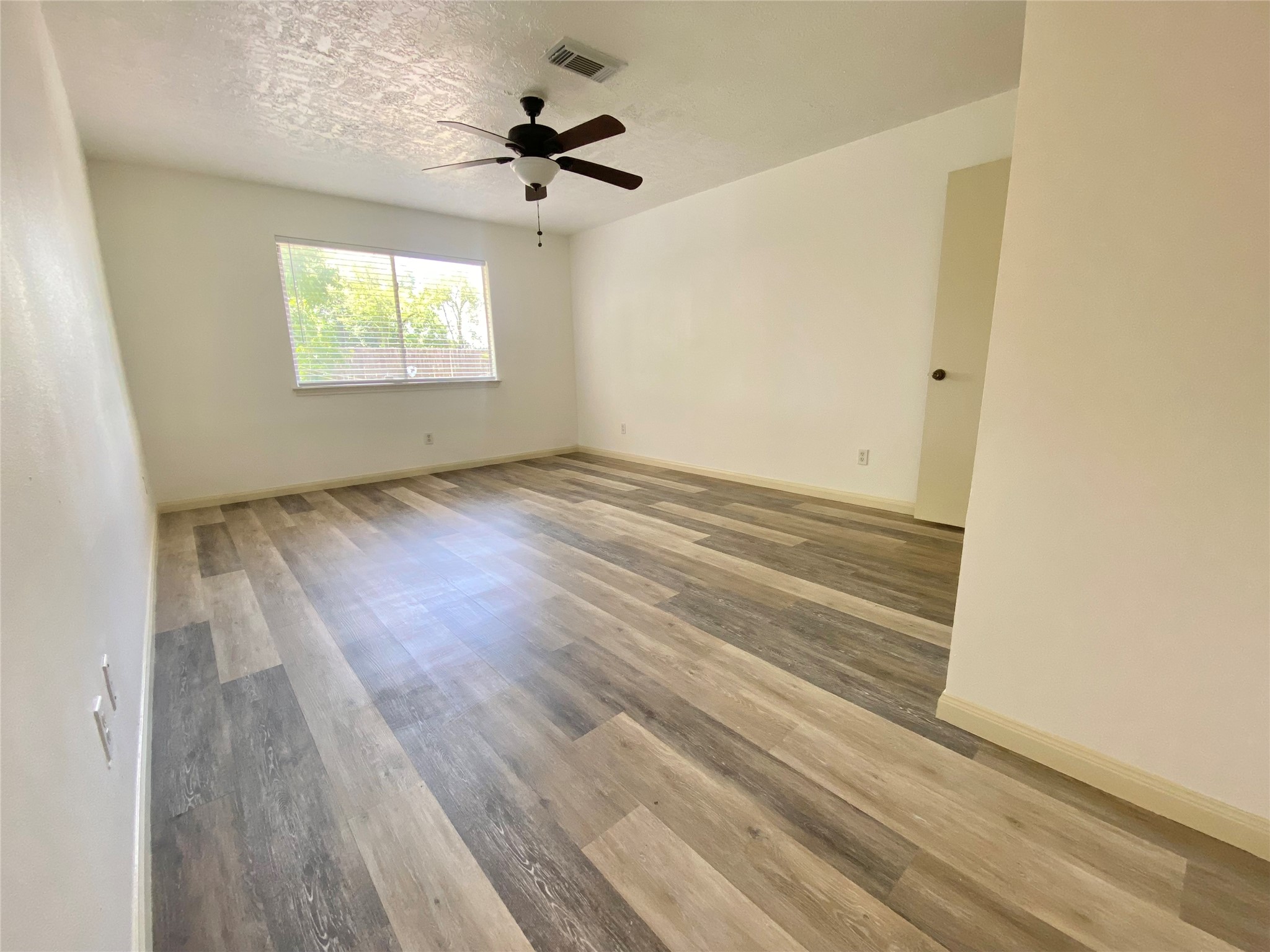 4203 Breckenridge Drive Houston, TX 77066 - Photo 11 of 43 an empty room with wooden floor and windows