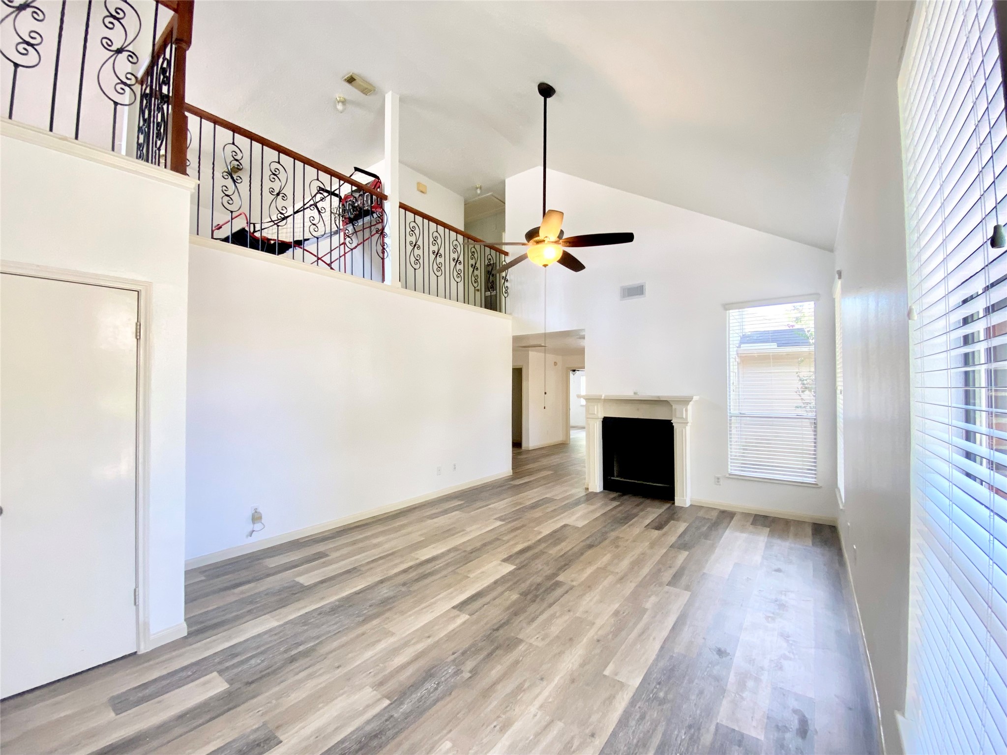 4203 Breckenridge Drive Houston, TX 77066 - Photo 2 of 43 a view of a livingroom with wooden floor staircase and a kitchen space