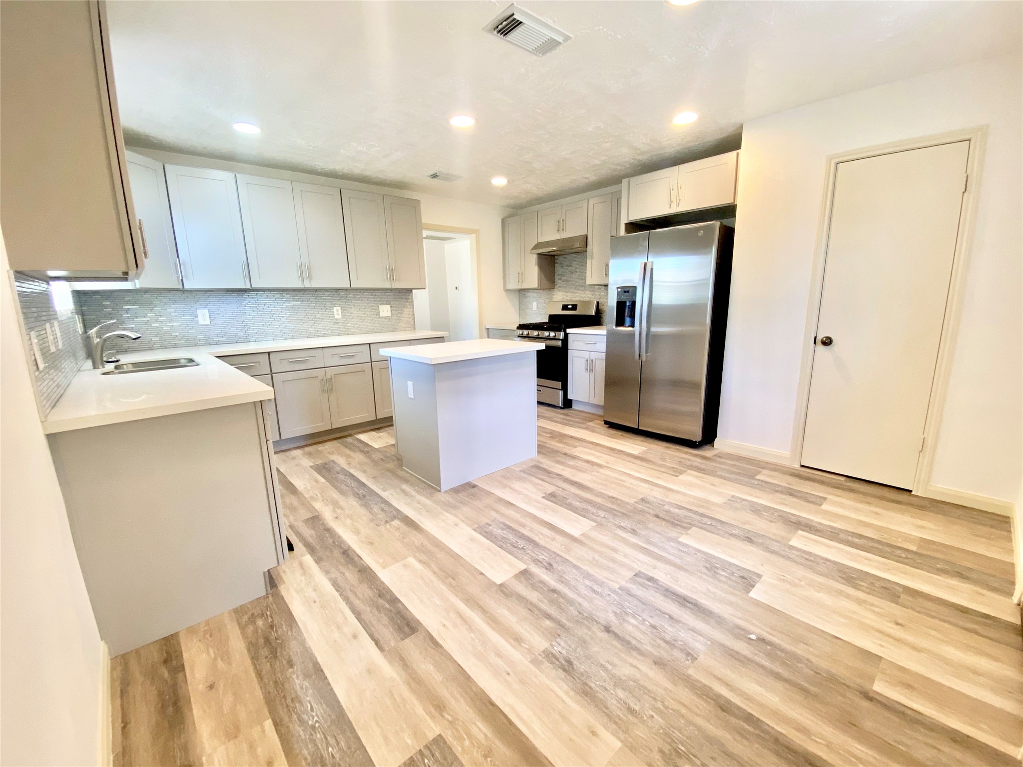 4203 Breckenridge Drive Houston, TX 77066 - Photo 24 of 43 a kitchen with a refrigerator sink and cabinets