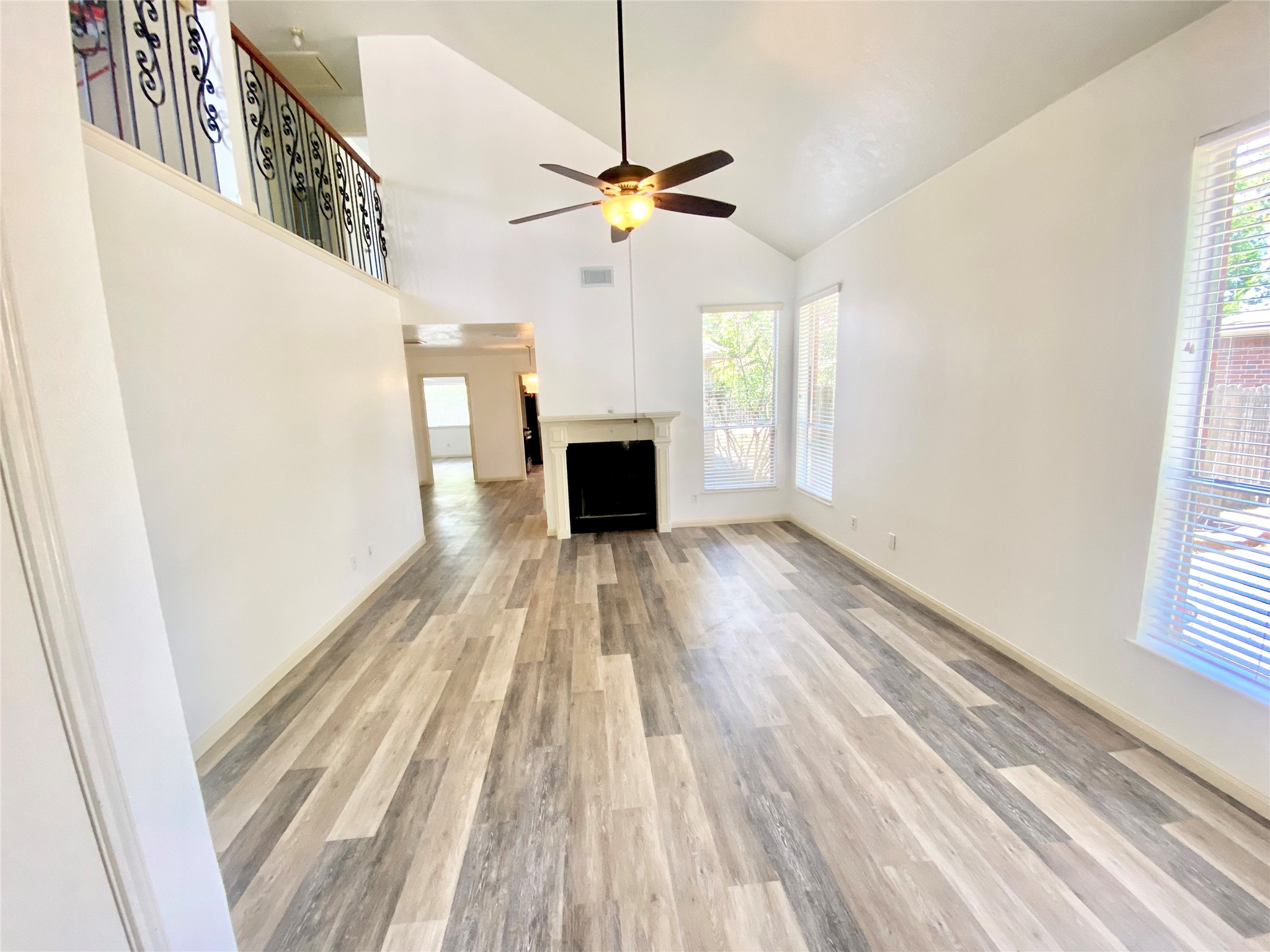 4203 Breckenridge Drive Houston, TX 77066 - Photo 3 of 43 a view of a livingroom with wooden floor a ceiling fan and windows
