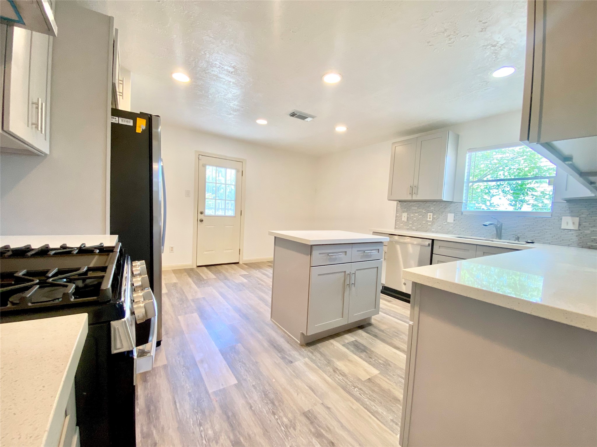4203 Breckenridge Drive Houston, TX 77066 - Photo 4 of 43 a kitchen with a stove and a refrigerator