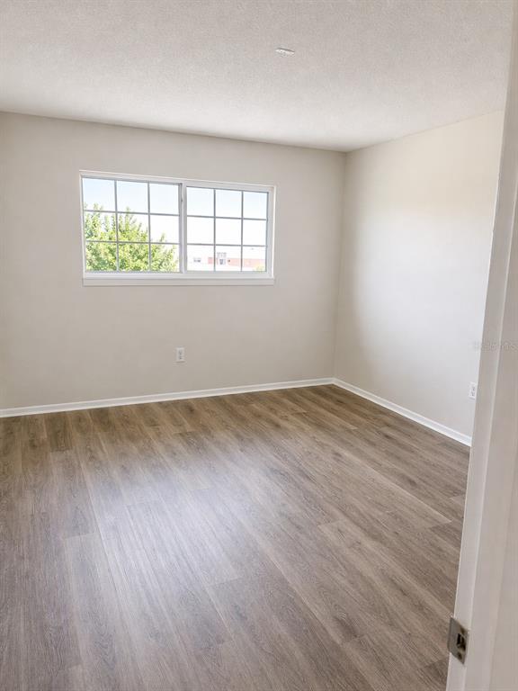 1695 Lee Road, Unit C206 Winter Park, FL 32789 - Photo 8 of 18 an empty room with wooden floor and windows
