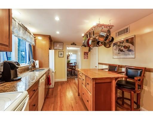 37 Arapahoe Road Newton, MA 02465 - Photo 12 of 30 a open kitchen with stainless steel appliances granite countertop a stove a sink dishwasher and a dining table with the view of living room