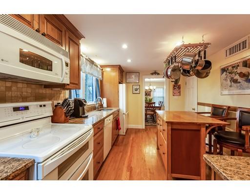 37 Arapahoe Road Newton, MA 02465 - Photo 13 of 30 a kitchen with stainless steel appliances granite countertop a sink dishwasher stove and wooden cabinets