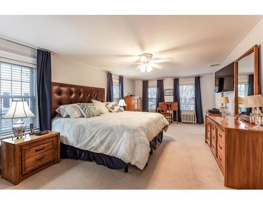37 Arapahoe Road Newton, MA 02465 - Photo 18 of 30 a spacious bedroom with a large bed and a chandelier