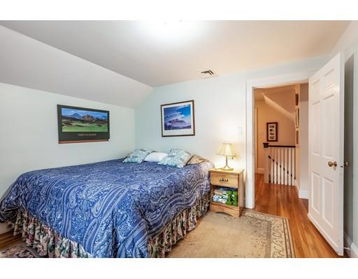 37 Arapahoe Road Newton, MA 02465 - Photo 23 of 30 a bedroom with a bed a mirror and a window