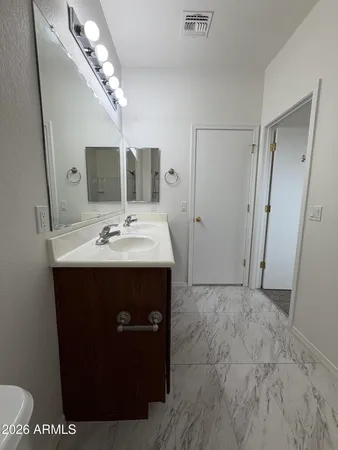 a bathroom with a sink a mirror and vanity
