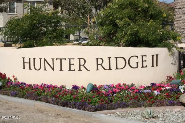 a sign that is in front of flowers