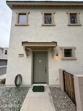 a front view of a house with parking space