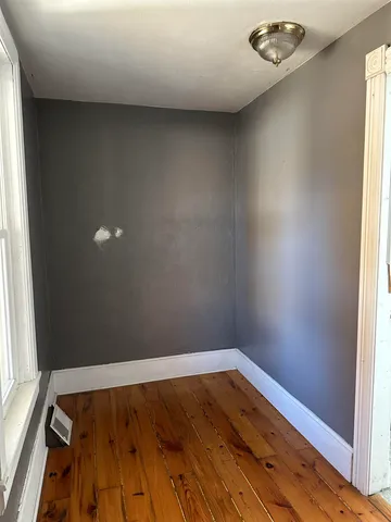 an empty room with wooden floor