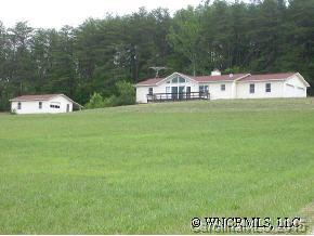 1942 Coopers Gap Road Mill Spring, NC 28756 - Photo 1 of 12 a view of house with outdoor space and garden