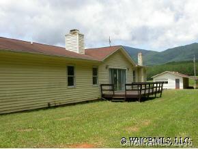 1942 Coopers Gap Road Mill Spring, NC 28756 - Photo 3 of 12 a front view of a house with a garden