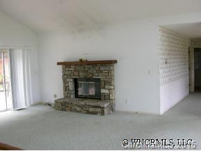 1942 Coopers Gap Road Mill Spring, NC 28756 - Photo 6 of 12 a living room with a fireplace